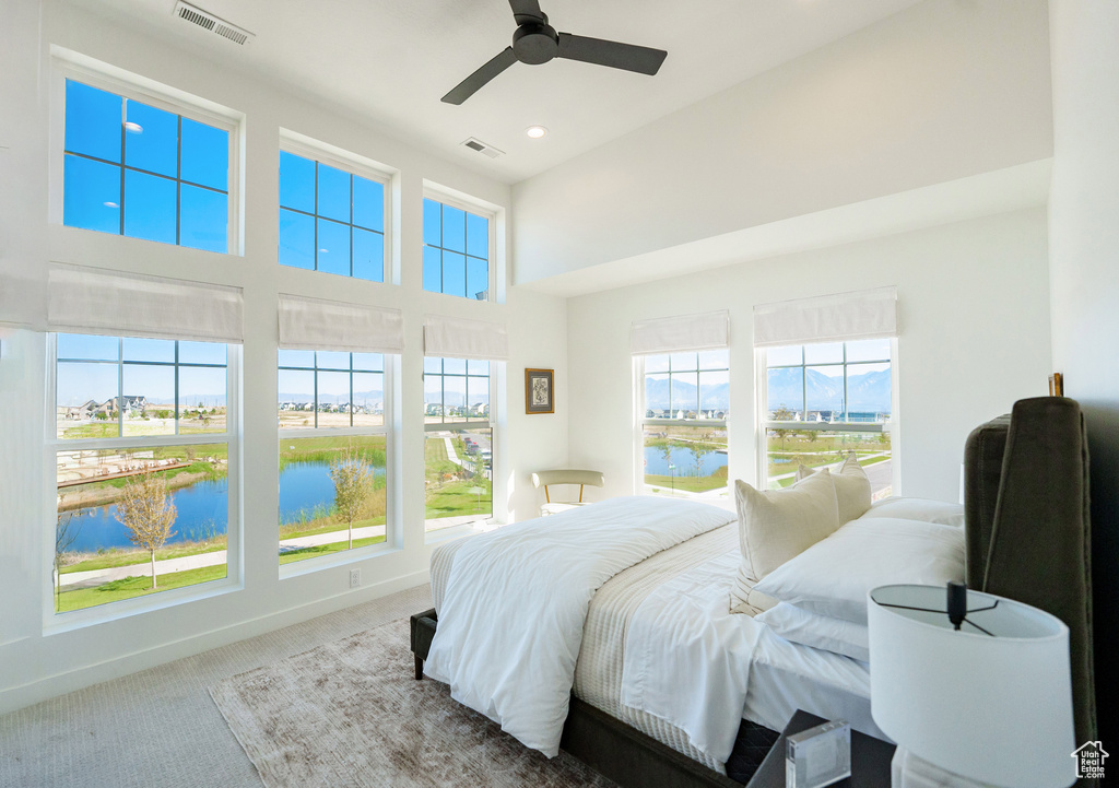 Carpeted bedroom featuring recessed lighting, baseboards, ceiling fan, and visible vents