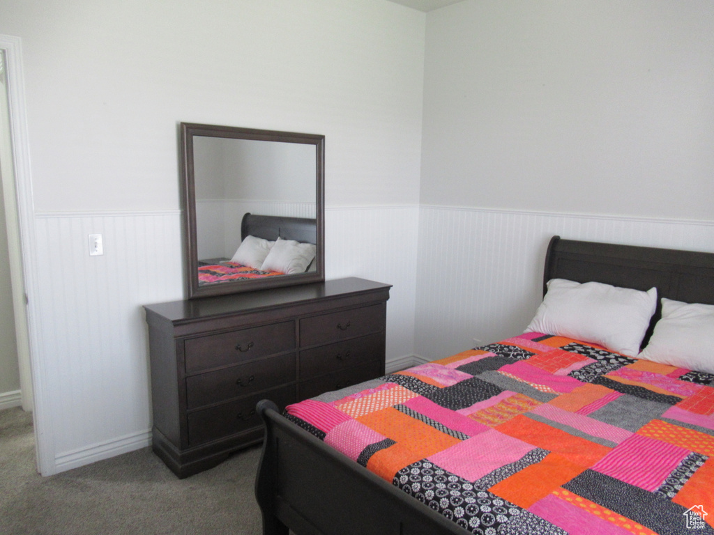 Bedroom featuring wainscoting and carpet flooring
