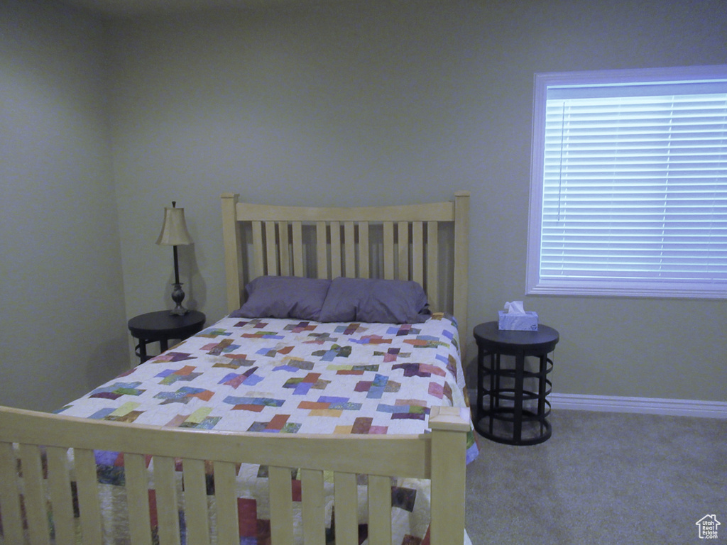 Bedroom featuring baseboards and carpet floors