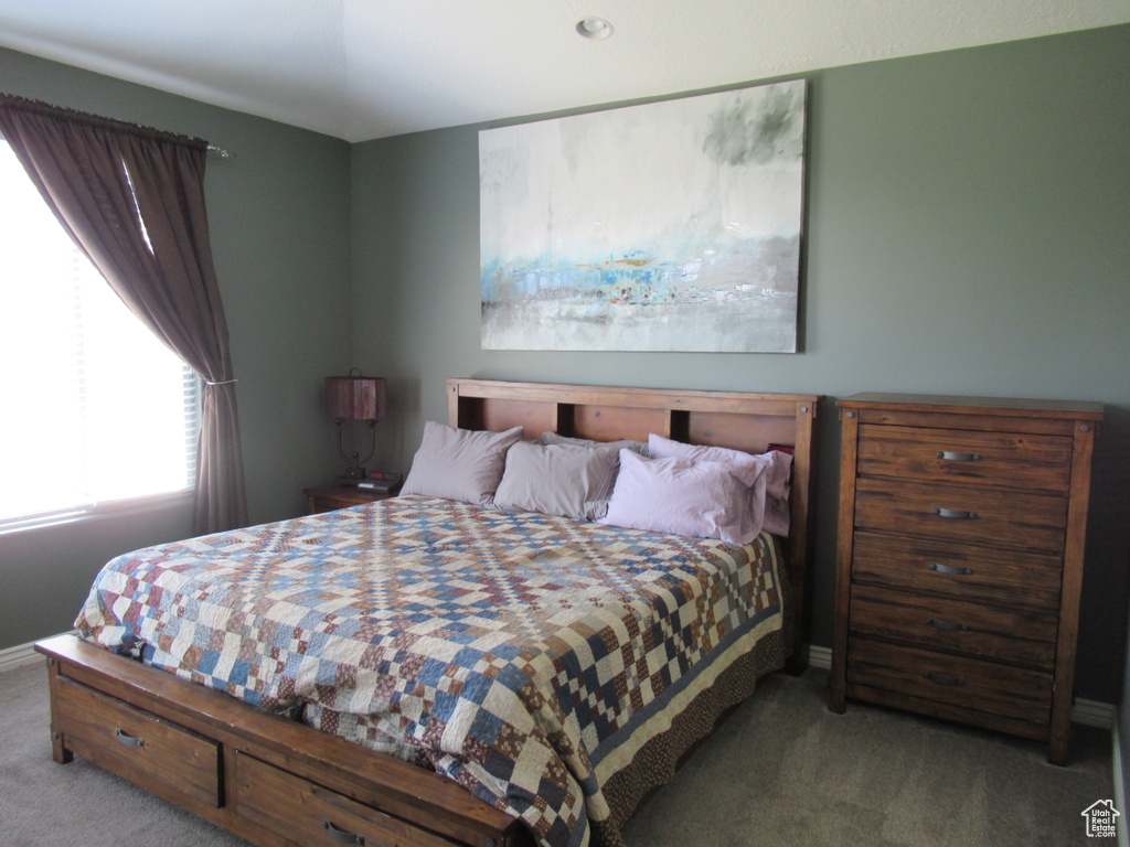 Carpeted bedroom featuring baseboards