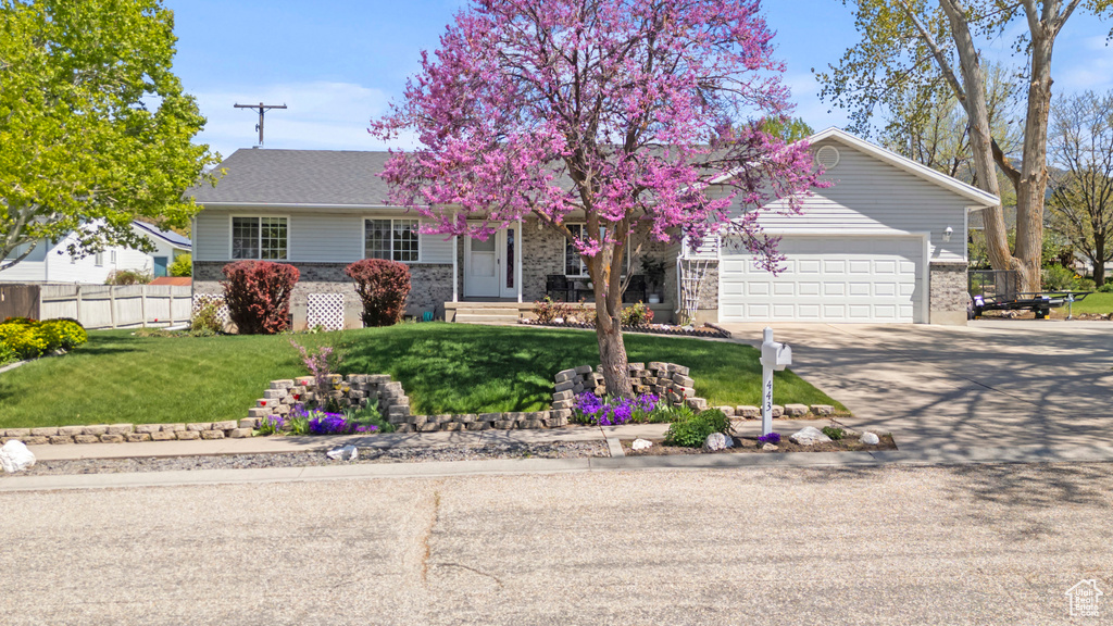 View of front of home featuring brick siding, driveway, and a garage