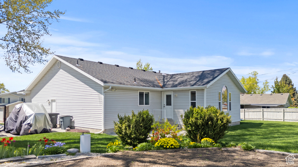 Back of property with roof with shingles