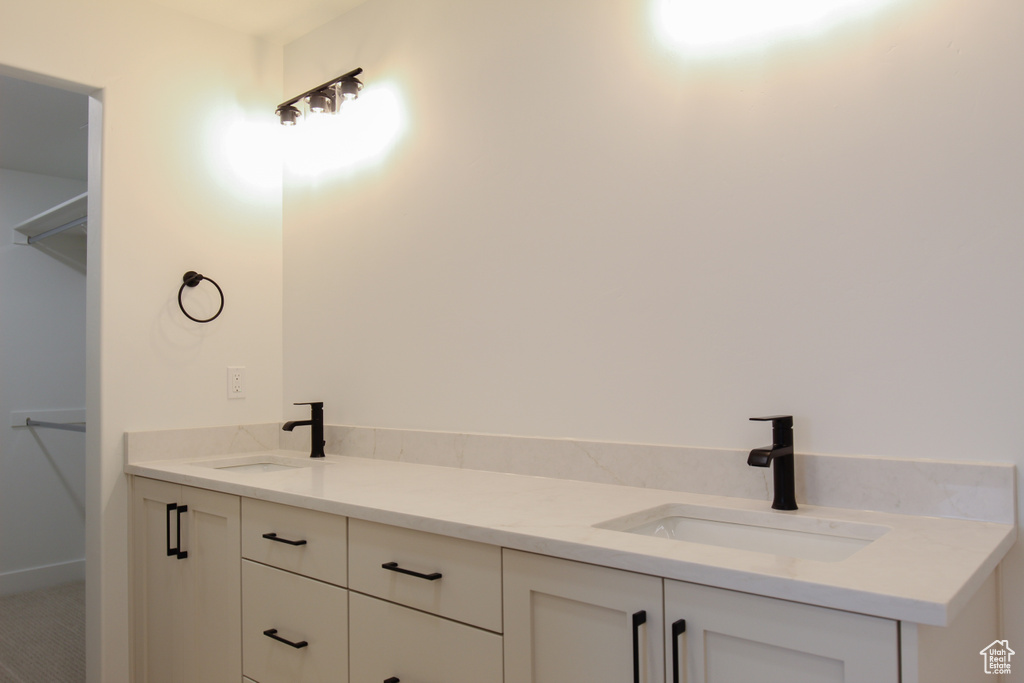 Full bathroom with double vanity and a sink