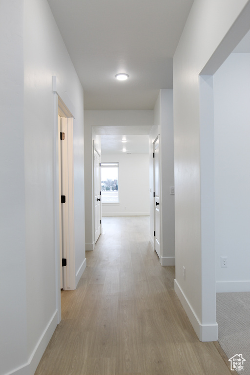 Hall featuring baseboards and light wood finished floors