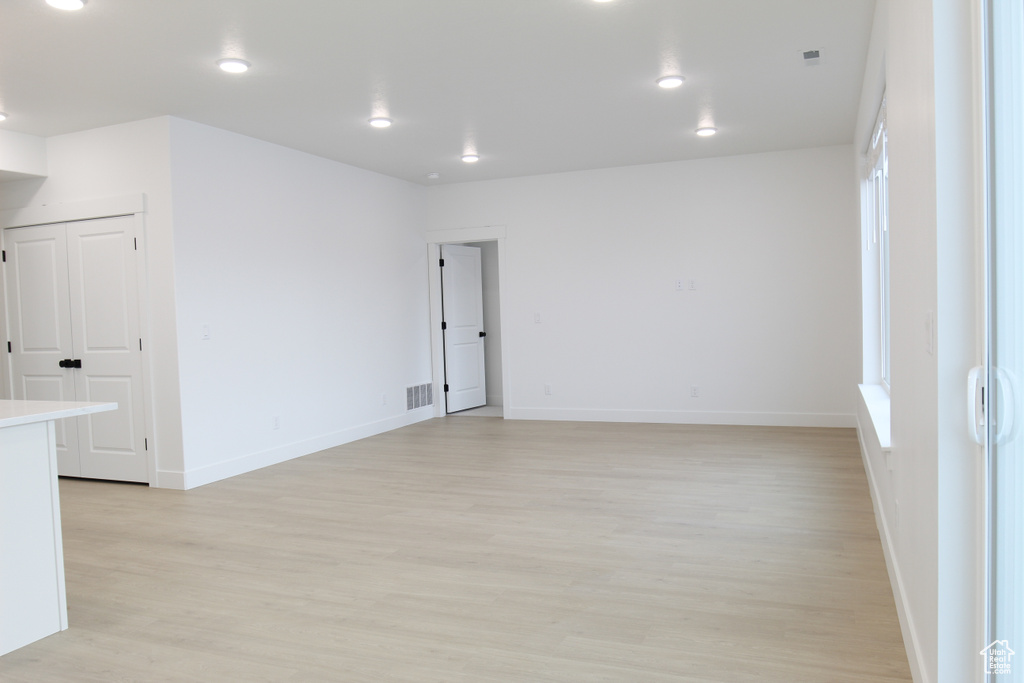 Empty room featuring baseboards, visible vents, recessed lighting, and light wood-type flooring