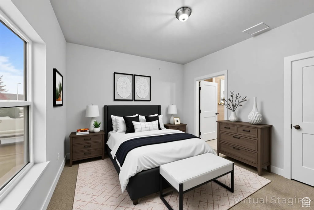 Bedroom featuring light carpet and baseboards