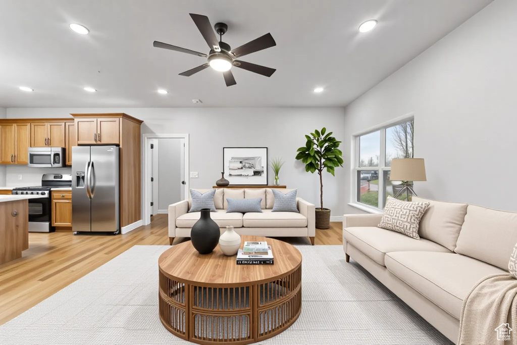Living area with ceiling fan, recessed lighting, light wood-style floors, and baseboards