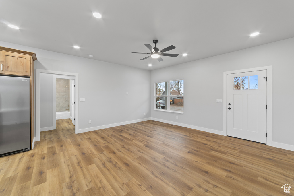 Unfurnished living room with ceiling fan, baseboards, light wood finished floors, and recessed lighting
