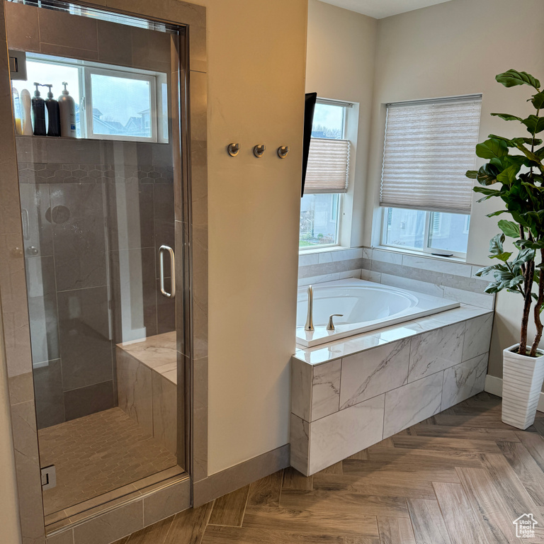Full bath featuring a shower stall, baseboards, and a bath