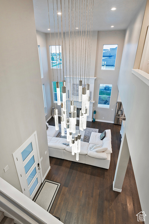 Interior space with a towering ceiling, recessed lighting, and wood finished floors
