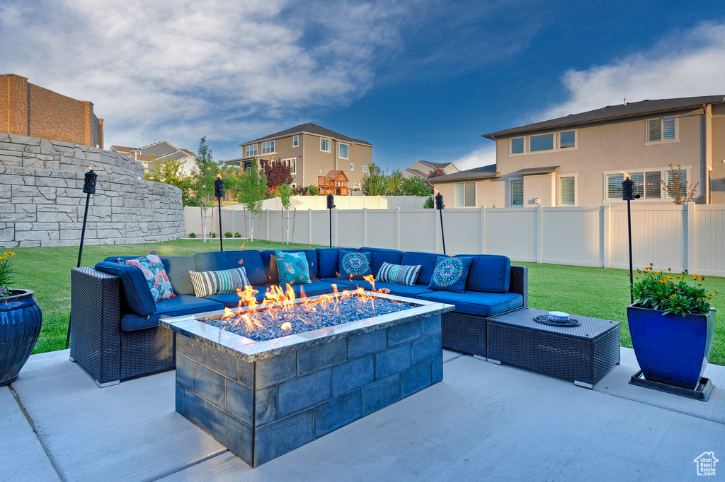 View of patio featuring a fenced backyard and an outdoor living space with a fire pit