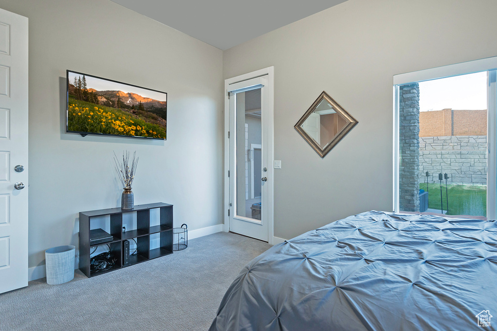 Bedroom featuring carpet and baseboards