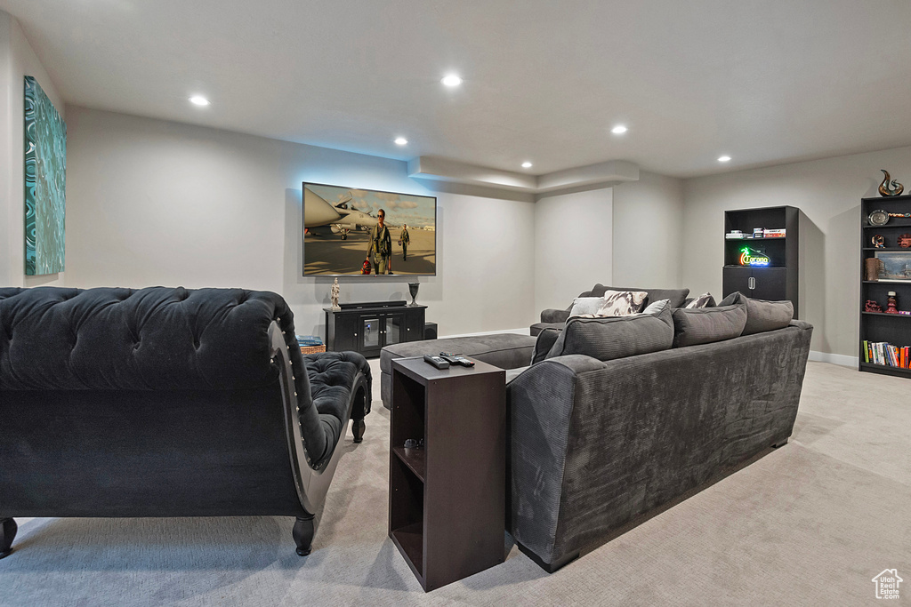 Living room featuring light colored carpet, baseboards, and recessed lighting