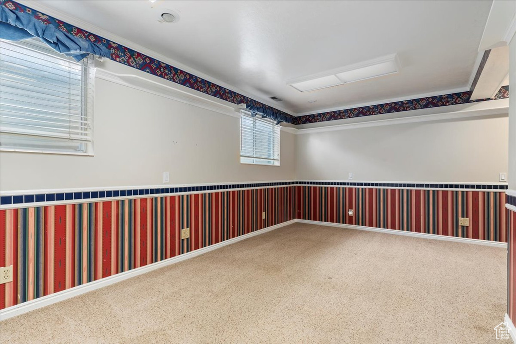 Carpeted spare room featuring wallpapered walls
