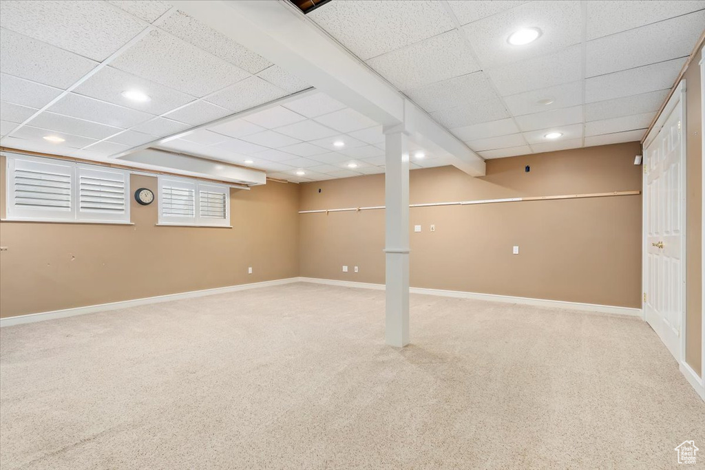 Finished below grade area featuring baseboards, recessed lighting, and carpet
