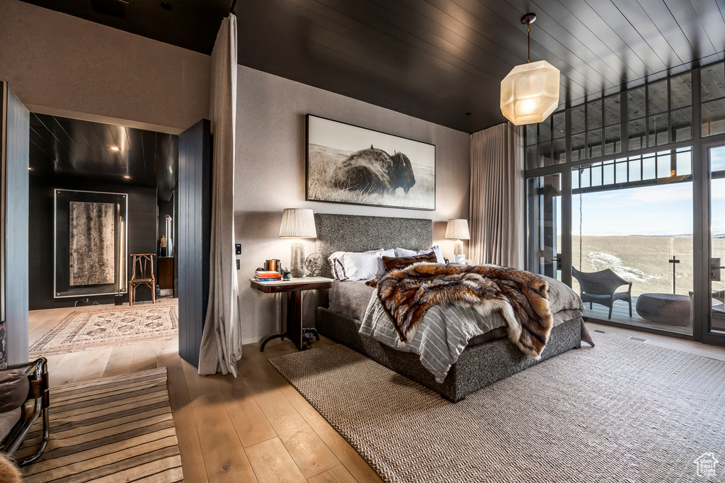 Bedroom featuring hardwood / wood-style floors and access to exterior