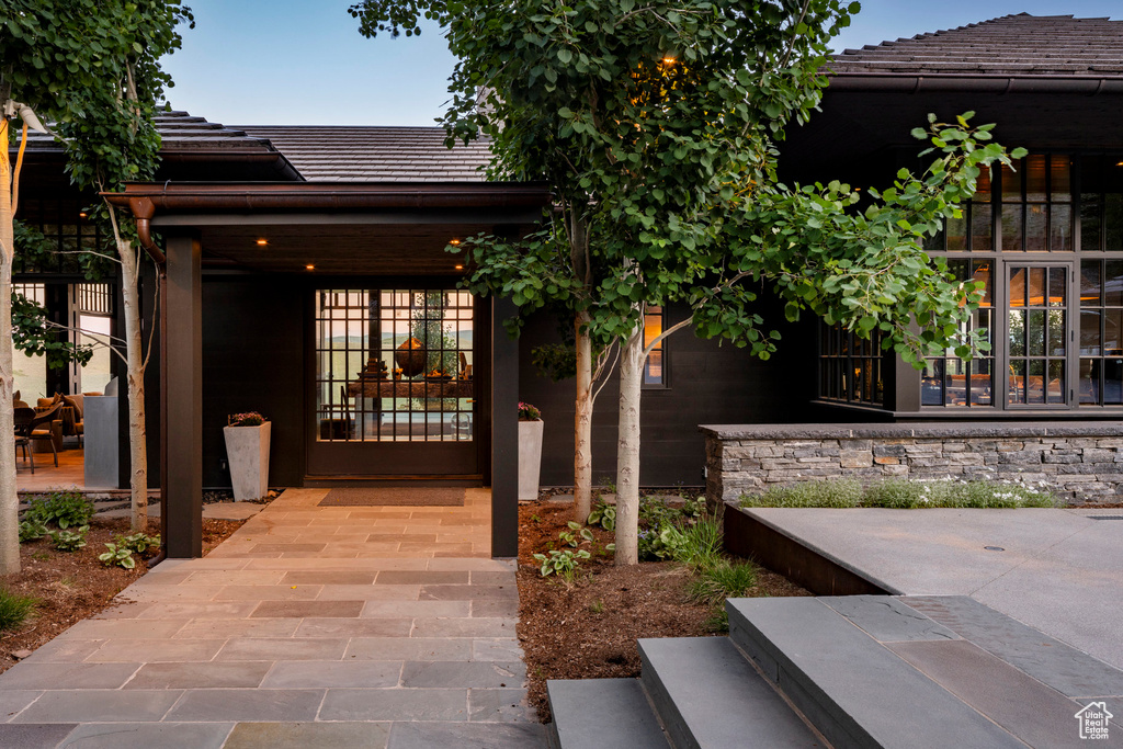View of exterior entry featuring a tiled roof