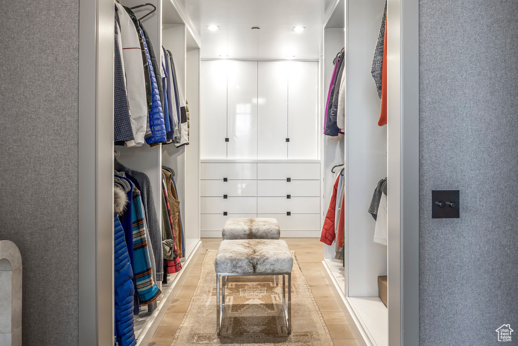 Spacious closet with light wood-style flooring