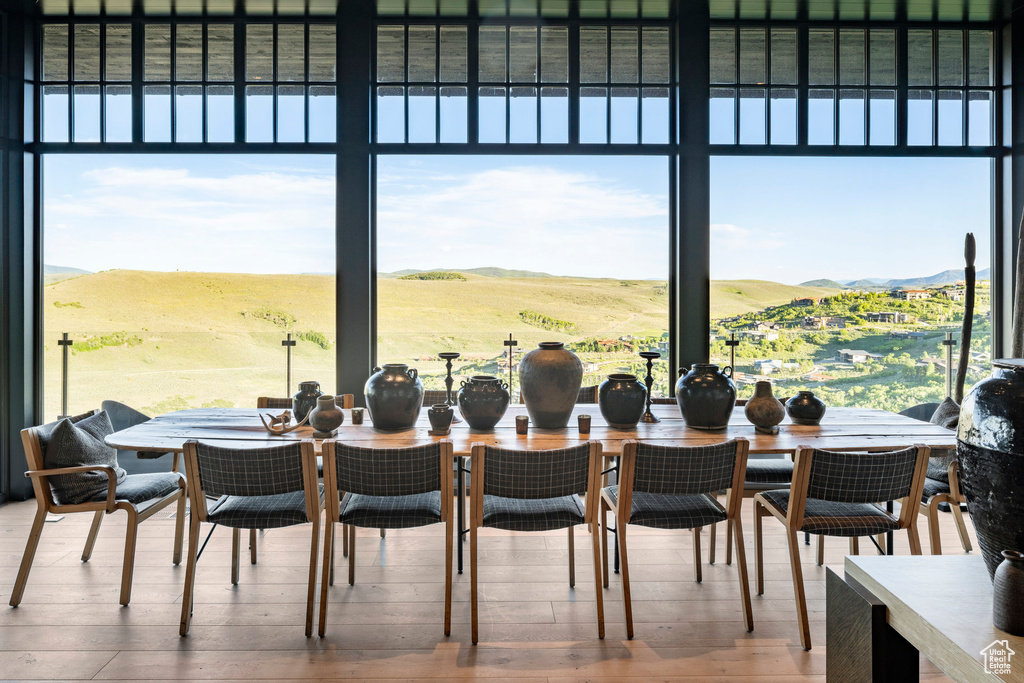 Dining room featuring hardwood / wood-style flooring, plenty of natural light, and a mountain view