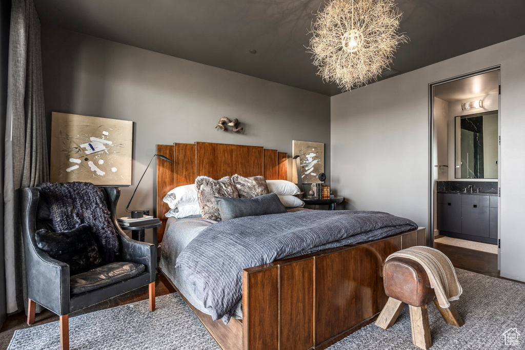 Bedroom featuring connected bathroom and wood finished floors