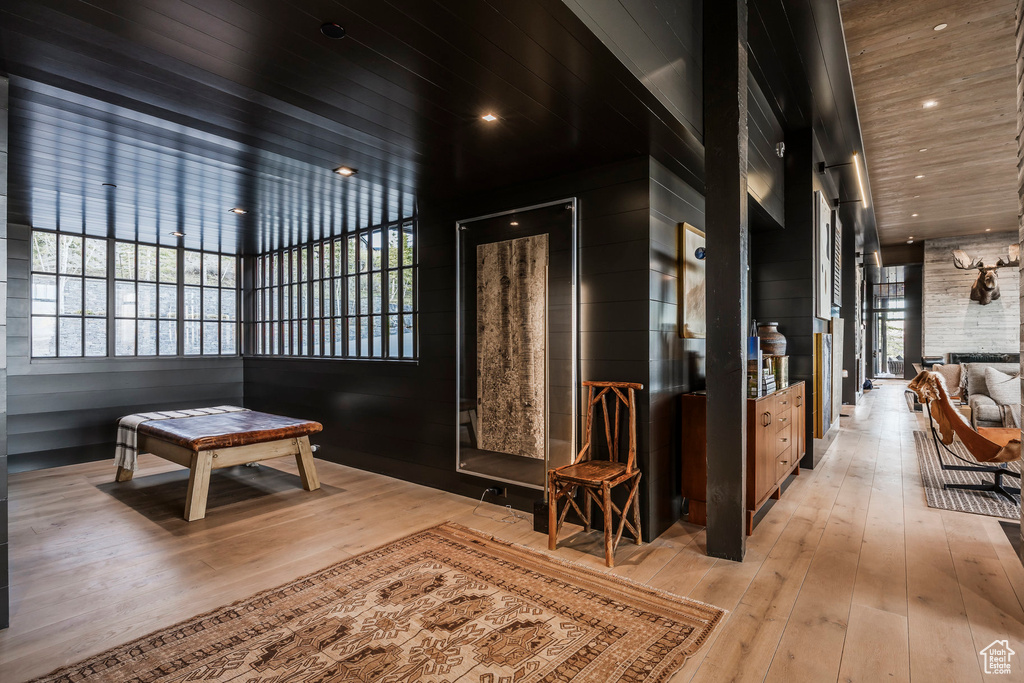 Corridor featuring hardwood / wood-style flooring, plenty of natural light, and wood ceiling