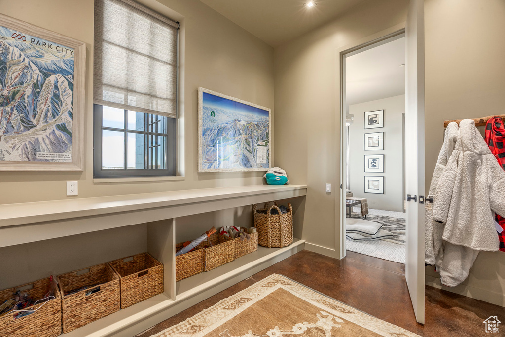 Mudroom with finished concrete floors and baseboards