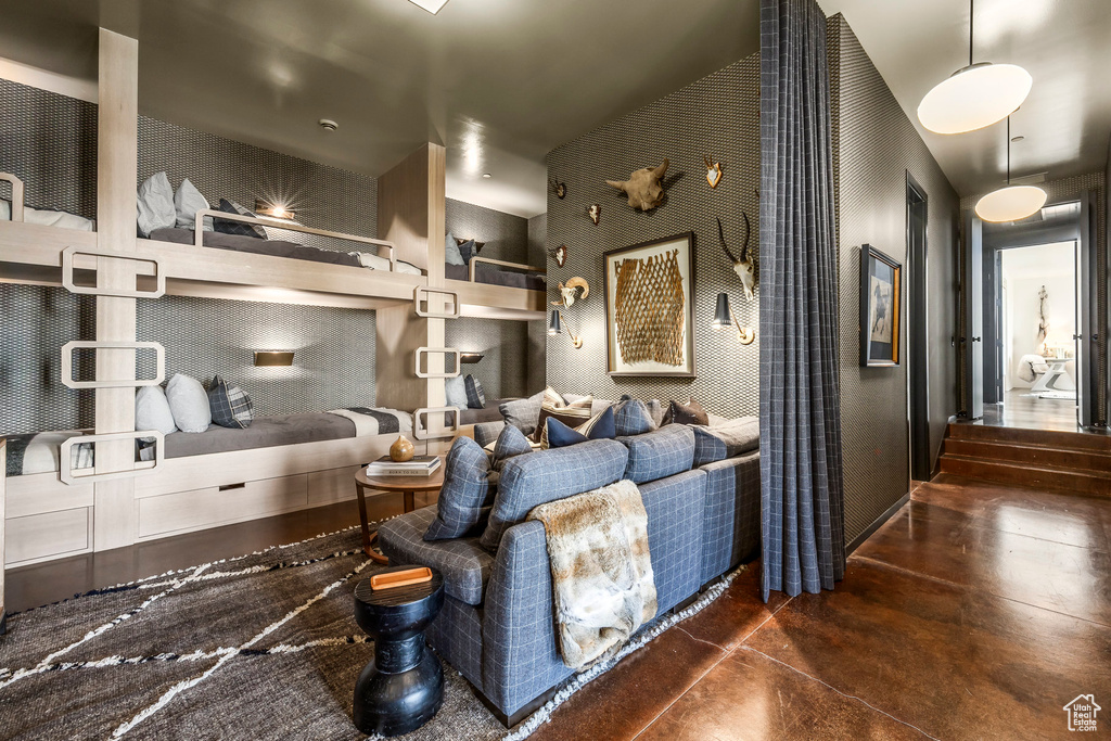Living area with finished concrete flooring and baseboards