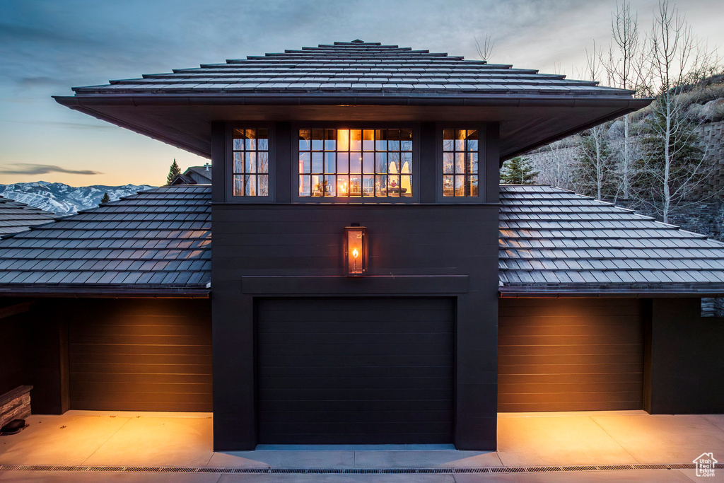 View of home's exterior with a garage and concrete driveway