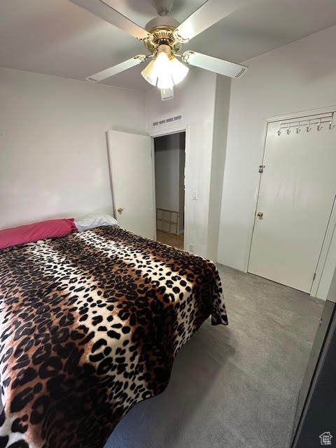 Bedroom featuring light colored carpet and a ceiling fan