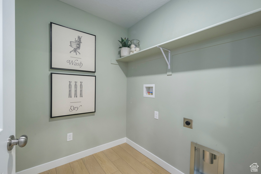 Laundry room featuring light wood-style flooring, washer hookup, baseboards, laundry area, and electric dryer hookup