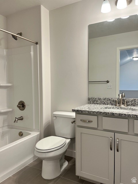 Full bath featuring tile patterned floors, toilet, bathing tub / shower combination, and vanity