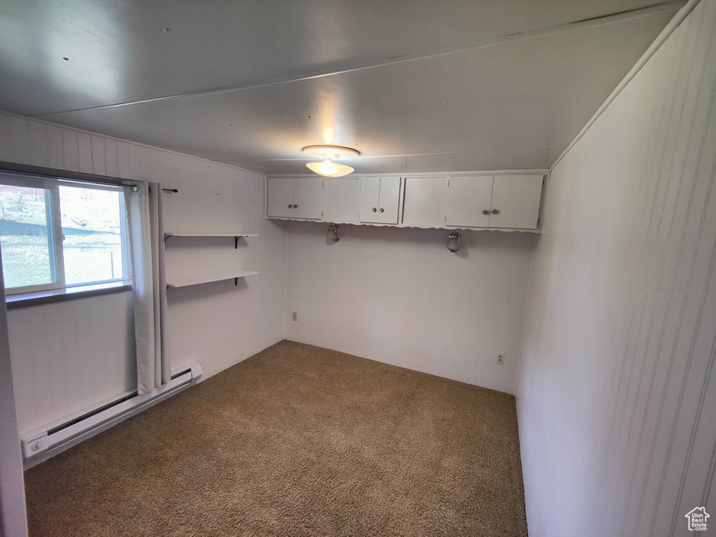 Spare room featuring carpet floors and a baseboard radiator