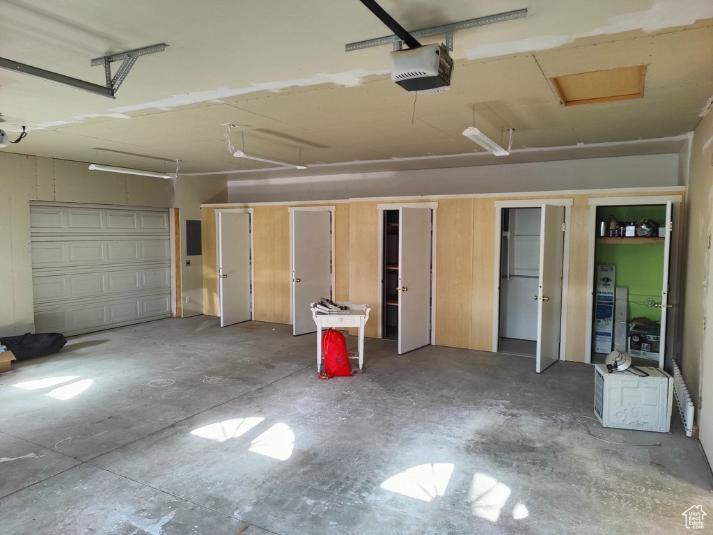 Garage with a garage door opener and electric panel