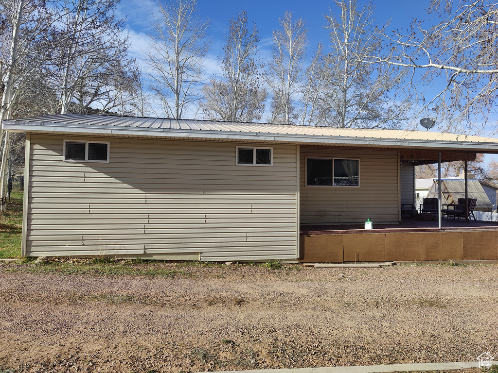 Back of property featuring metal roof