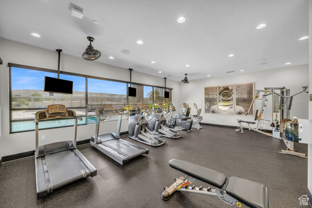 Workout area with baseboards and recessed lighting