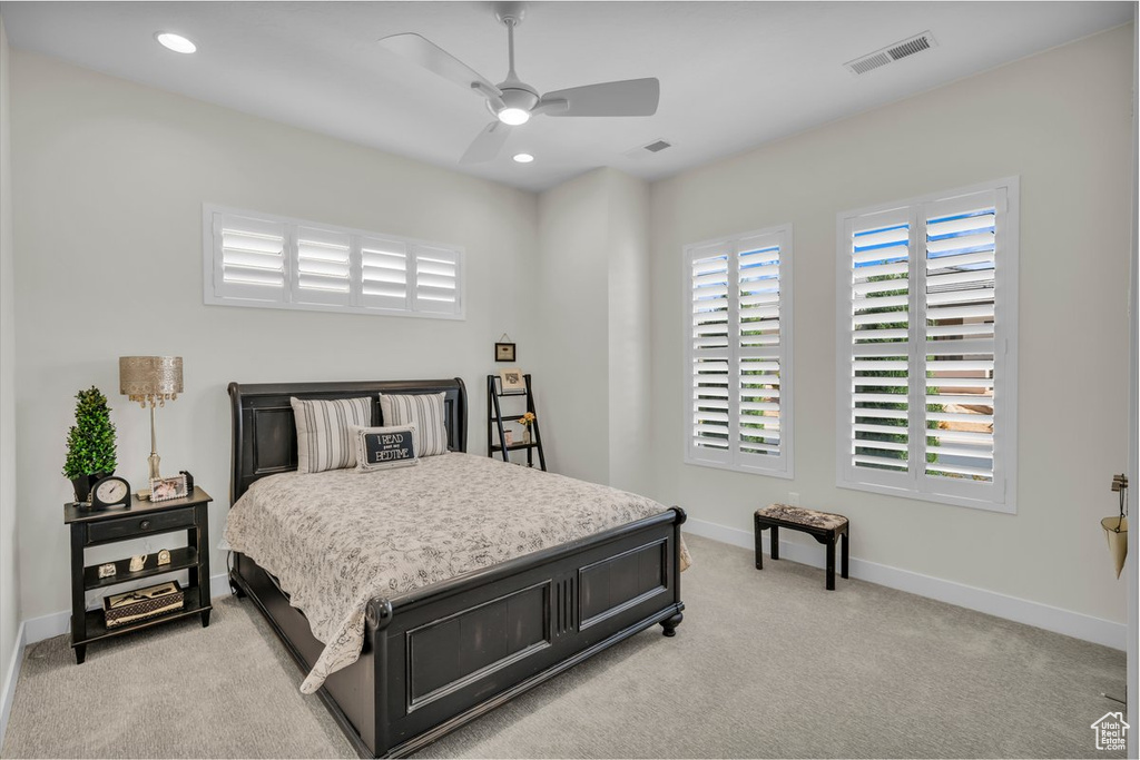 Bedroom with light colored carpet, recessed lighting, baseboards, visible vents, and a ceiling fan
