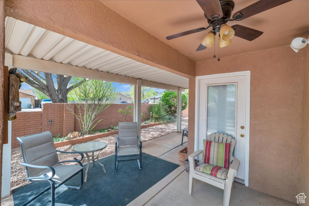 View of patio / terrace with fence and a ceiling fan