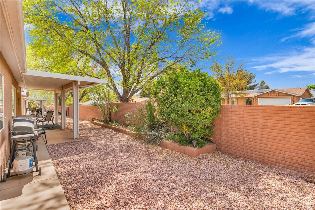 View of yard featuring a patio and a fenced backyard