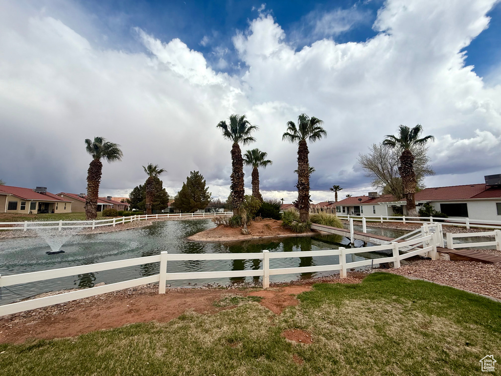 View of yard with a water view and fence