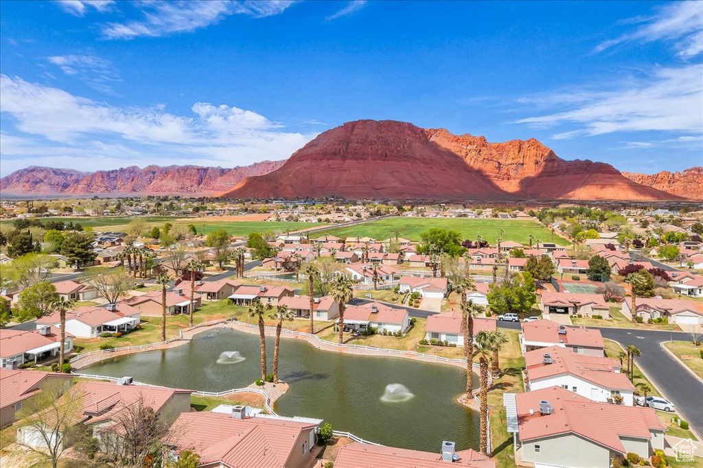 Birds eye view of property featuring a water and mountain view and a residential view