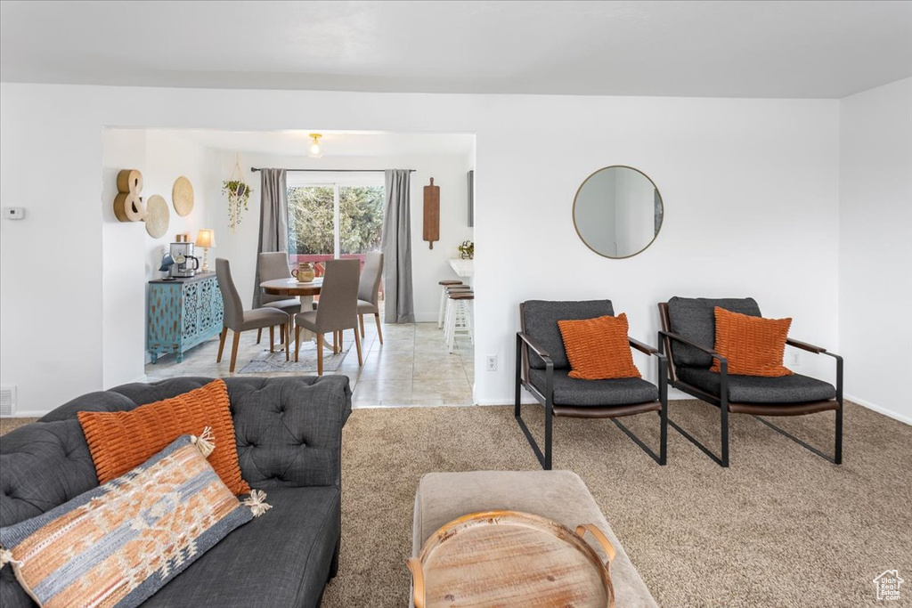 Living room featuring baseboards and carpet
