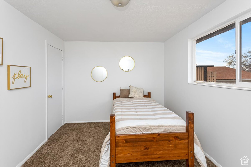 Carpeted bedroom with baseboards