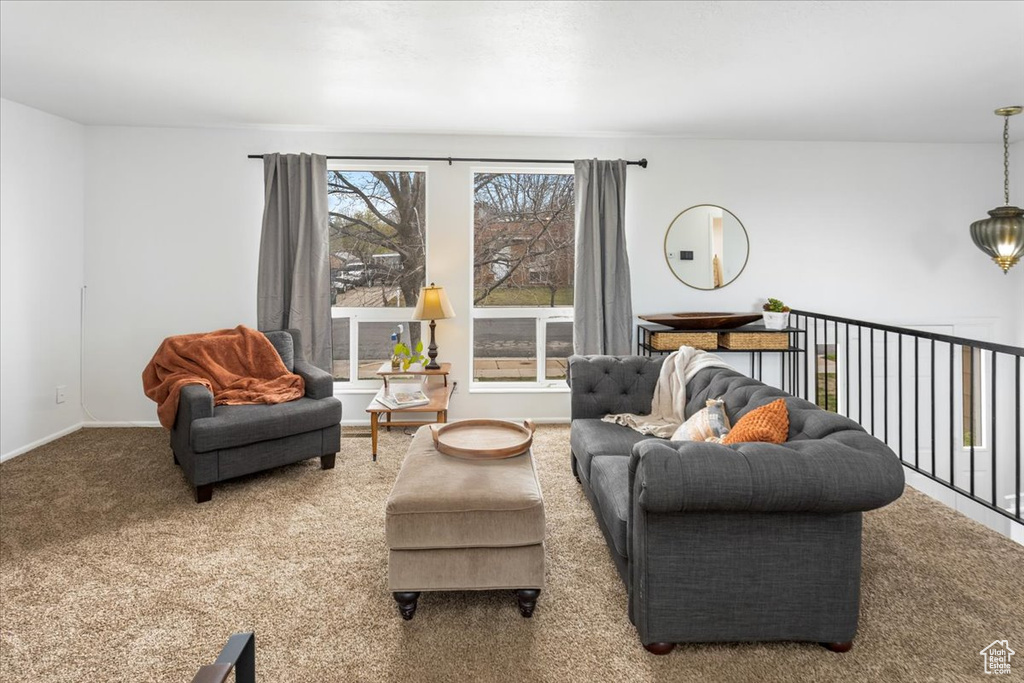 Carpeted living area with baseboards