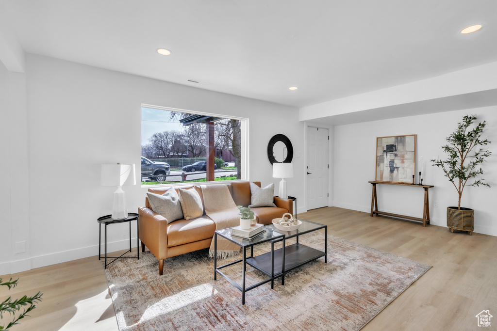 Living room with wood finished floors and recessed lighting