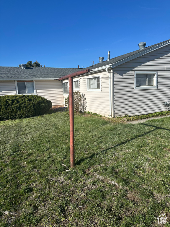 Back of property with a yard