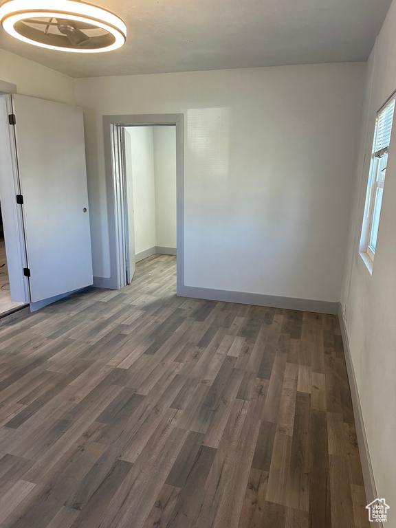 Spare room featuring baseboards and wood finished floors