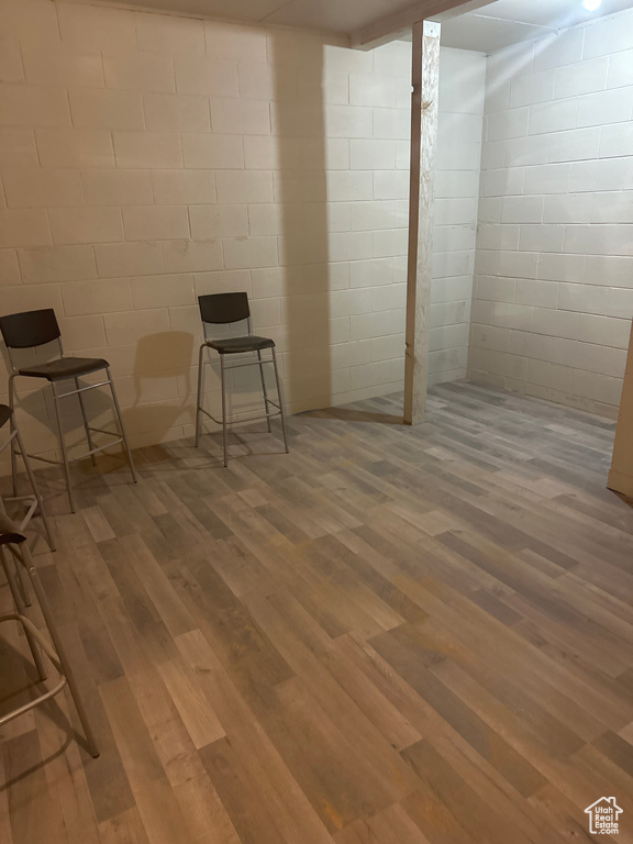 Finished below grade area with concrete block wall and wood finished floors