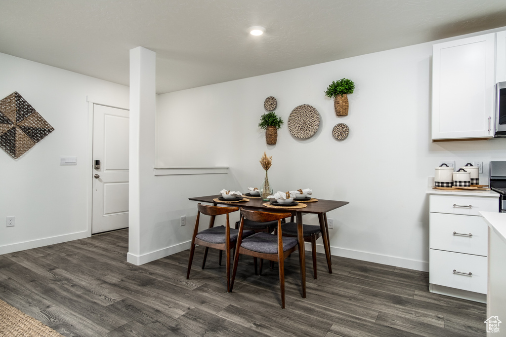 Dining room with baseboards and dark wood finished floors