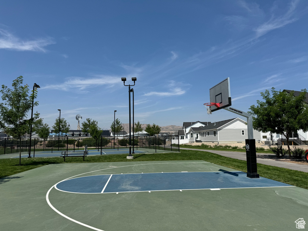 View of sport court with a tennis court, community basketball court, and fence