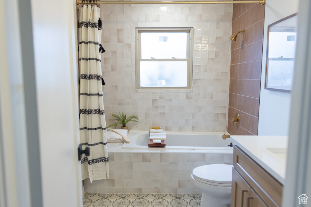 Full bath featuring toilet, tiled shower / bath, and vanity